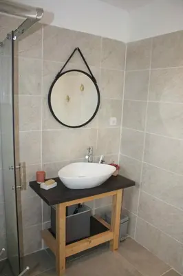 a bathroom with a sink and a mirror on the wall at Résidence U Rapalinu in Molini