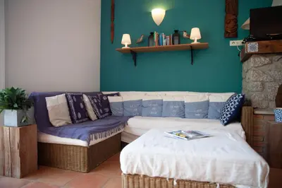 a living room with a couch and a table at Casa Vadde Lungha superbe vue mer 8 personnes in Coti-Chiavari