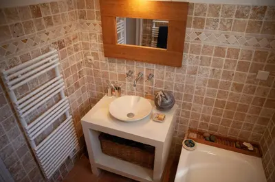 a bathroom with a sink and a mirror at Casa Vadde Lungha superbe vue mer 8 personnes in Coti-Chiavari