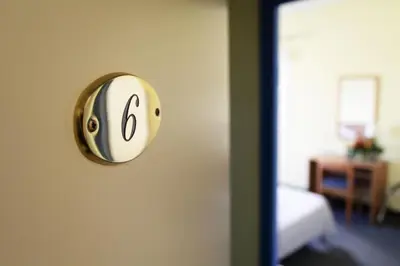 a room with a clock on the wall at Hôtel Des Nacres in Ventiseri