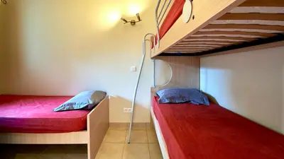 a bedroom with two bunk beds in a room at Vacancéole - Résidence Lisa Maria in Favone