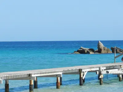 a pier in the ocean with blue water at Apartment Cala Sultana-3 by Interhome in Usciolo