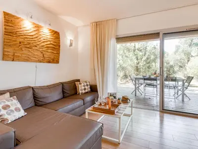 a living room with a couch and a table at Apartment Cala Sultana-7 by Interhome in Usciolo