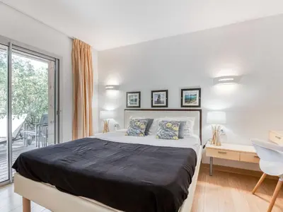 a bedroom with a bed and a desk and a window at Apartment Cala Sultana-7 by Interhome in Usciolo
