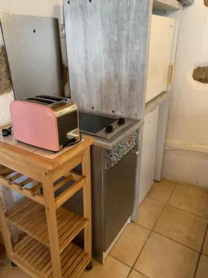 a small kitchen with a toaster on a table at Caseddu di Chjarastella in Figari