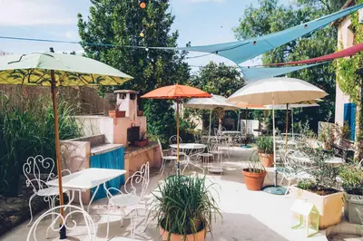 a patio with tables and chairs and umbrellas at Chez Marie in Linguizzetta