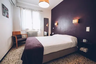 a hotel room with a bed and a chair at Chez Marie in Linguizzetta