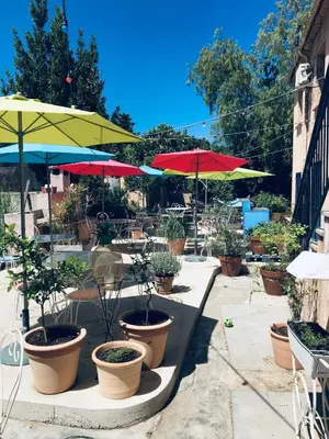 a patio with a bunch of plants and umbrellas at Chez Marie in Linguizzetta