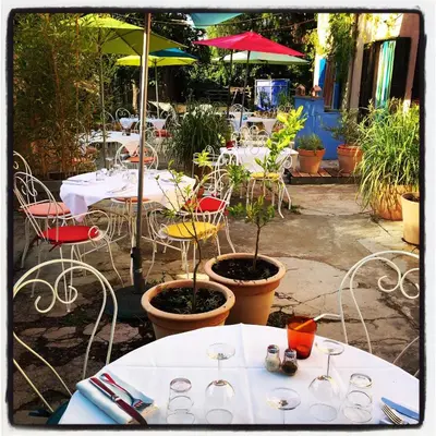 a group of tables and chairs at a restaurant at Chez Marie in Linguizzetta