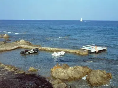 a group of boats in the water near the shore at Les Bungalows de Figha in Tarcu