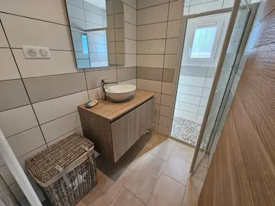 a bathroom with a sink and a mirror at Emma in Sari Solenzara