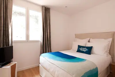a hotel room with a bed and a television at Superbe T3 sur la Marina de Bonifacio in Bonifacio