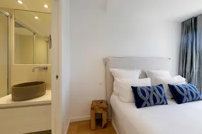 a bedroom with a bed with a shower and a tub at Superbe T3 sur la Marina de Bonifacio in Bonifacio