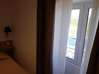 a bedroom with a desk and a tv in a room at L'Escale chambres privées chez l'habitant JFDL in Bonifacio