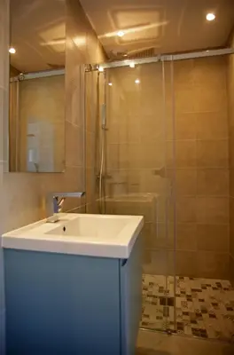 a bathroom with a sink and a shower at Villa Vue Mer, piscine chauffée, tennis in Porticcio