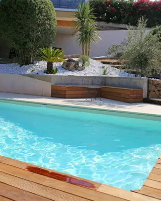 a swimming pool in a yard with a dog laying on the ground at Villa Vue Mer, piscine chauffée, tennis in Porticcio