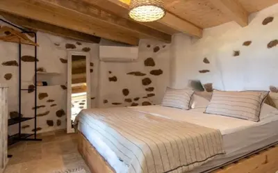a bedroom with a large bed in a room at Tour Génoise Micalona, Domaine de l'Oglisatru in Olmeto