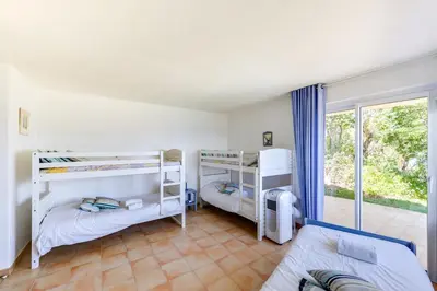 a bedroom with two bunk beds and a window at La Veglia in Porto-Vecchio