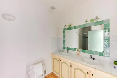 a bathroom with two sinks and a mirror at La Veglia in Porto-Vecchio