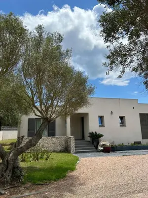 a house with a tree in front of it at La villa Serena in Bonifacio