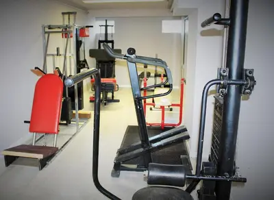 a fitness room with a gym with tread machines at Appart Hotel Corte HR in Corte