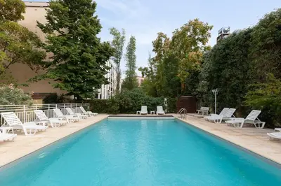 a swimming pool with lounge chairs and a swimming pool at Appart Hotel Corte HR in Corte