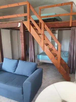 a living room with a bunk bed and a couch at English Club in Corsica A in Porri