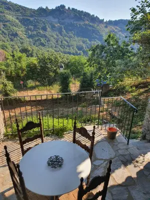 a table and chairs on a patio with a view at English Club in Corsica A in Porri