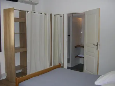 a bedroom with a bed and a closet and a shower at Hotel Costa Verde in Moriani Plage