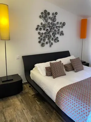 a bedroom with a bed with pillows on it at Mariana Plage in La Marana