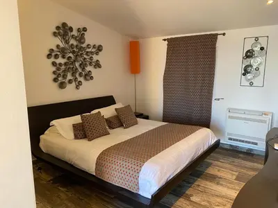 a bedroom with a bed and a chandelier at Mariana Plage in La Marana