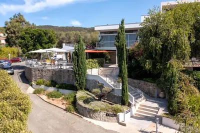 an aerial view of a building with trees at Hotel Les Eucalyptus in Porto Pollo