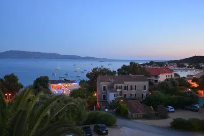 a view of a town with boats in the water at Hotel Les Eucalyptus in Porto Pollo