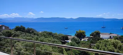 a view of a large body of water from a balcony at Hotel Les Eucalyptus in Porto Pollo