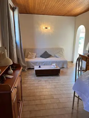 a living room with a couch and a table at Gîte à Poggiale de Figari in Figari