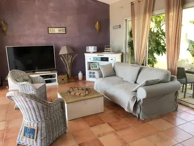 a living room with a couch and a tv at Villa Rosa in Conca