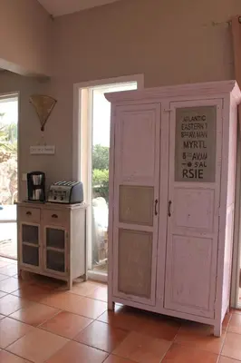 a kitchen with a cabinet and a stove in a room at Villa Rosa in Conca