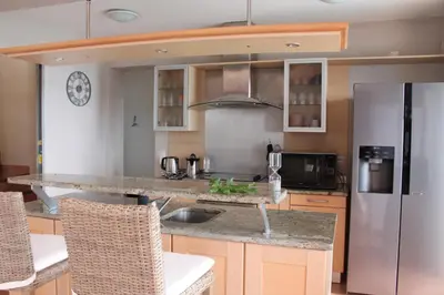 a kitchen with a sink and a refrigerator at Villa Rosa in Conca