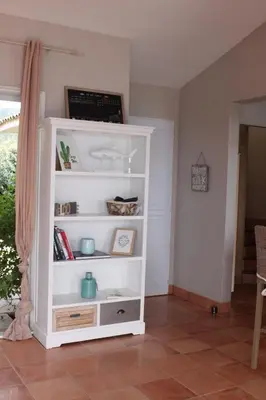 a white book shelf in a living room at Villa Rosa in Conca