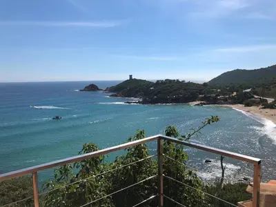 a view of a beach with a lighthouse in the distance at Villa Rosa in Conca