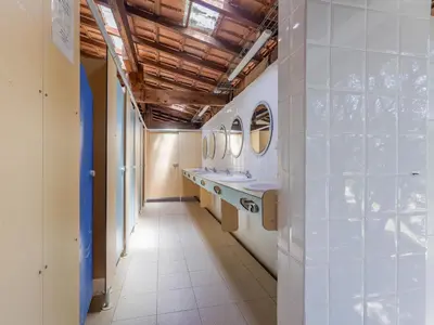 a hallway with sinks and mirrors in a bathroom at Camping Torraccia in Cargèse