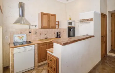 a kitchen with a sink and a counter top at Awesome Home In Santa Maria Poggio in Santa-Maria-Poggio