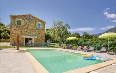 a swimming pool with a pool noodle in front of a house at Awesome Home In Santa Maria Poggio in Santa-Maria-Poggio