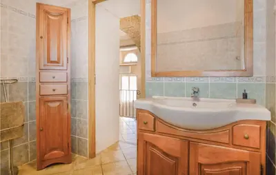 a bathroom with a sink and a mirror at Amazing Home In Santa Maria Poggio in Santa-Maria-Poggio