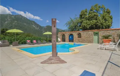 a swimming pool with a pole next to a building at Beautiful Home In Santa Maria Poggio in Santa-Maria-Poggio