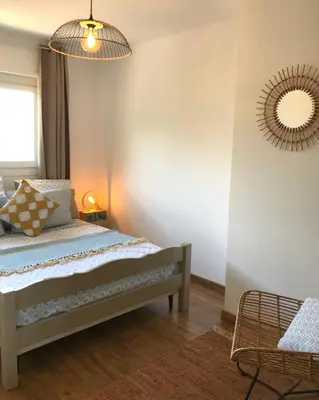 a bedroom with a bed and a mirror on the wall at Duplex vue mer in Sagone