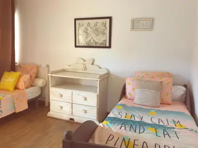 a childs bedroom with a bed and a dresser at Duplex vue mer in Sagone