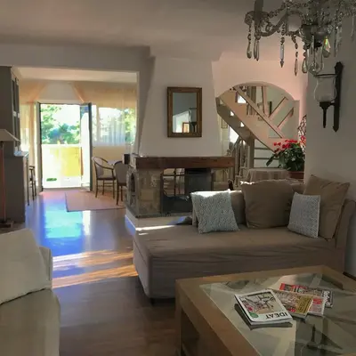 a living room with a couch and a fireplace at Duplex vue mer in Sagone