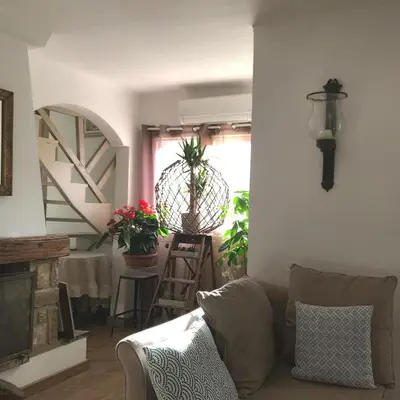 a living room with a couch and a table at Duplex vue mer in Sagone