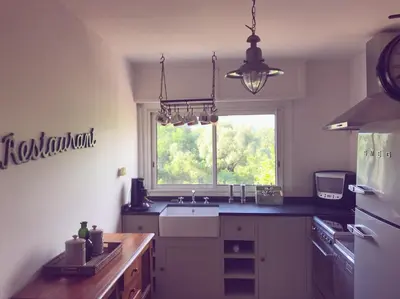 a kitchen with a sink and a window at Duplex vue mer in Sagone